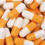 Several orange and white antiretroviral drugs.