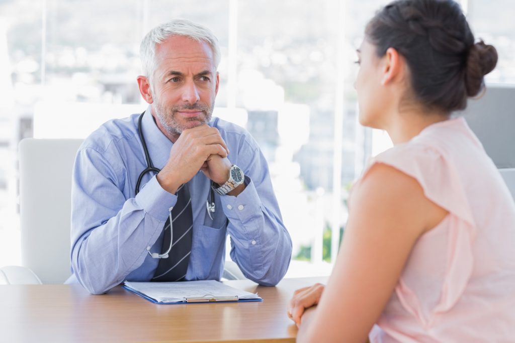 A doctor talking to his patient about their diagnosis, and early HIV intervention.